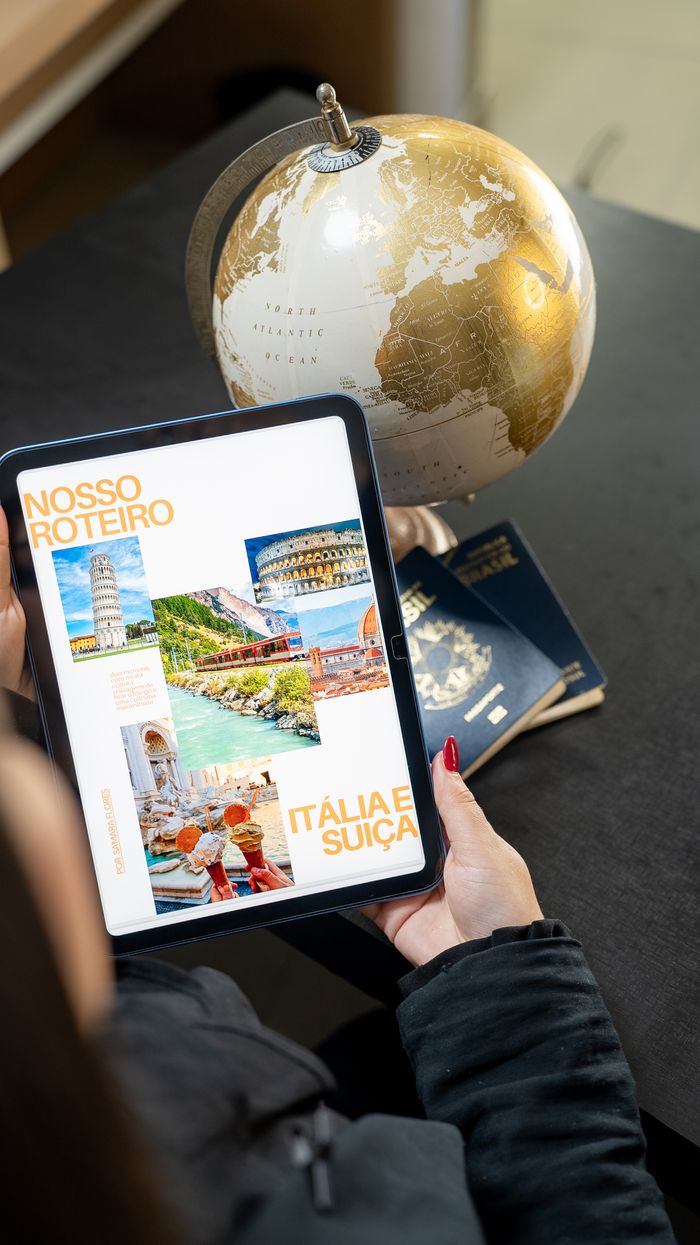 project-03-b Traveler planning a trip to Italy and Switzerland using a globe, tablet, and passports.